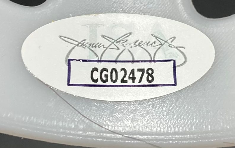A white oval CG02478 sticker with faint logo and signature is attached to the light gray, textured plastic of a Sports Integrity Ari Lehman Signed Jason Vorhees White Costume Mask (Jason 1, Jason Never Dies, JSA).