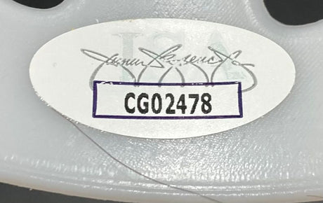 A white oval CG02478 sticker with faint logo and signature is attached to the light gray, textured plastic of a Sports Integrity Ari Lehman Signed Jason Vorhees White Costume Mask (Jason 1, Jason Never Dies, JSA).