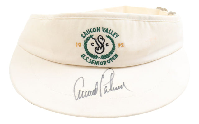 The Sports Integrity Arnold Palmer Signed 1992 PGA US Senior Open Visor features a white design with green logo, "Saucon Valley U.S. Senior Open 1992" embroidery, and Arnold Palmer's large autograph in black marker on the brim.
