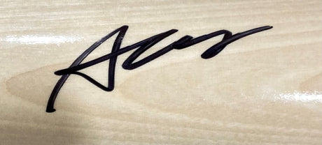A bold black marker signature features on a tan Rawlings Pro baseball bat, signed by Austin Wells of the New York Yankees. Available from Sports Integrity.
