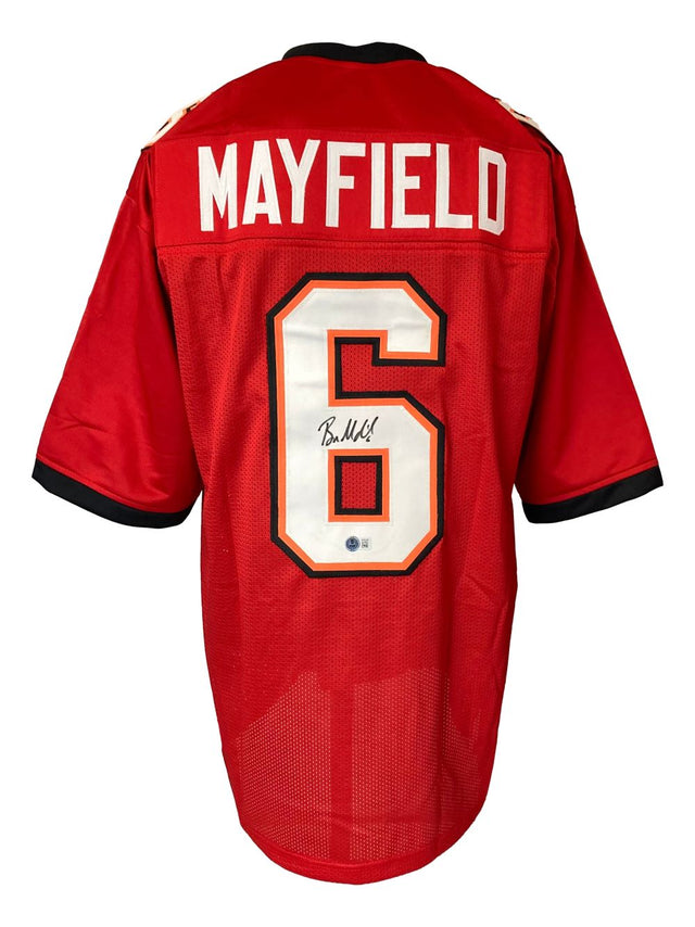A Baker Mayfield Tampa Bay Signed Red Football Jersey by Sports Integrity featuring "MAYFIELD" and number 6 on the back, with the number autographed in black marker.