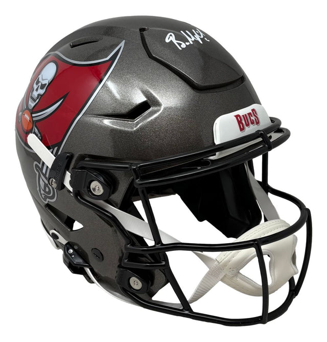 The Baker Mayfield Signed Tampa Bay Buccaneers FS Authentic SpeedFlex Helmet by Sports Integrity features a black shell, team logo, white facemask, and Baker Mayfield’s autograph in white on top.