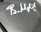 Close-up of a Baker Mayfield signed Tampa Bay Buccaneers FS Authentic SpeedFlex Helmet by Sports Integrity, showing his bold white autograph on the metallic gray surface.