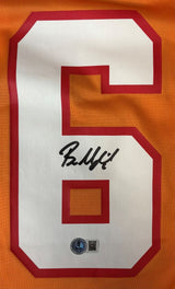 The Baker Mayfield Signed Tampa Bay Buccaneers Orange Nike Game Replica Jersey by Sports Integrity features a white number 6 with red outline on orange fabric, black autograph on the number, and a round QR authentication sticker below.