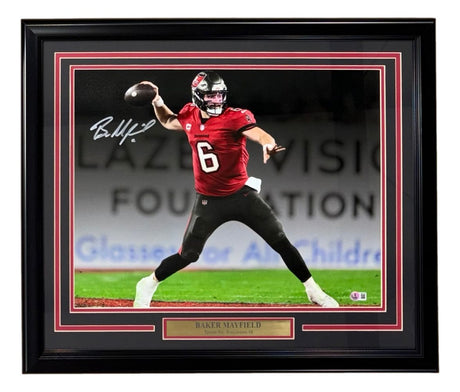 Sports Integrity Baker Mayfield Signed Framed 16x20 Buccaneers Spotlight Red Jersey Photo (BAS)—features the QB mid-throw in a red #6 jersey, with an autograph and plaque.