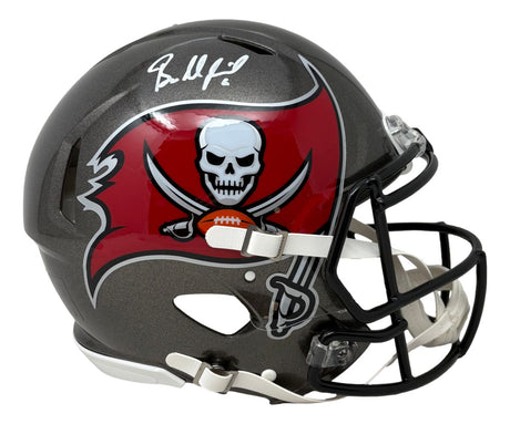 The Sports Integrity Baker Mayfield Signed Tampa Bay Buccaneers Full Size Authentic Helmet BAS features the team's pirate flag logo on the side and includes Mayfield's autograph on top.