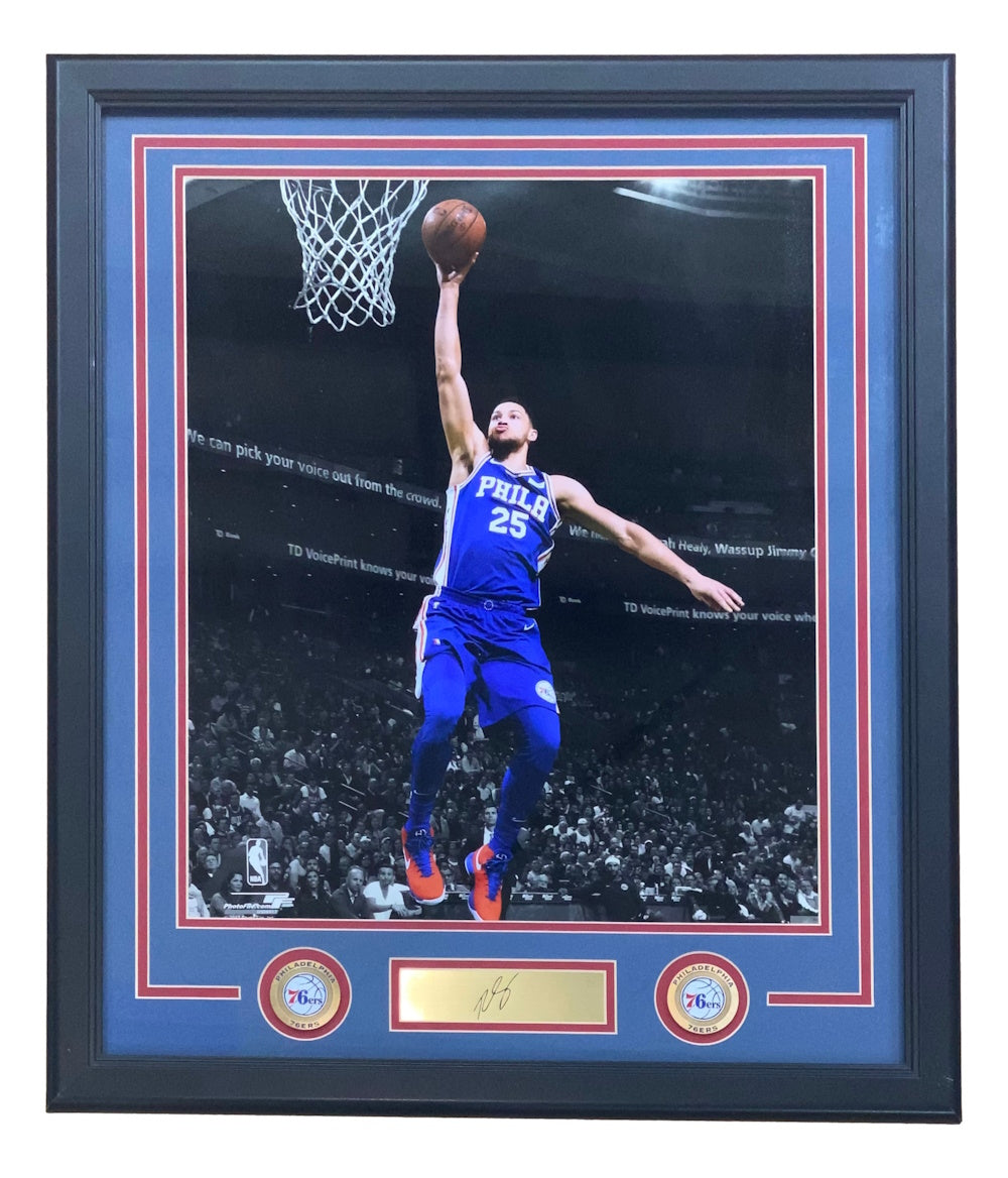 Sports Integrity Ben Simmons Framed 16x20 Philadelphia 76ers photo features him in a blue No. 25 jersey leaping for a layup, with a laser-engraved signature, gold nameplate, and two 76ers logos displayed underneath.
