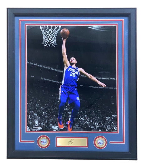 Sports Integrity Ben Simmons Framed 16x20 Philadelphia 76ers photo features him in a blue No. 25 jersey leaping for a layup, with a laser-engraved signature, gold nameplate, and two 76ers logos displayed underneath.