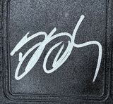 A bold, white autograph is inscribed in a looping style on the textured black surface of the Bill Goldberg WCW Signed Full Size Big Gold Heavyweight Championship by Sports Integrity.