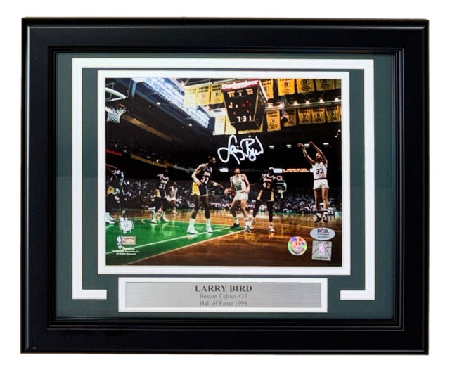 Sports Integrity Larry Bird Signed Framed 8x10 Photo – Celtics vs Lakers. Features Bird in a white uniform shooting, autograph in white ink, and plaque: “LARRY BIRD, Boston Celtics #33, Hall of Fame 1998.” Authenticated by PSA/DNA.