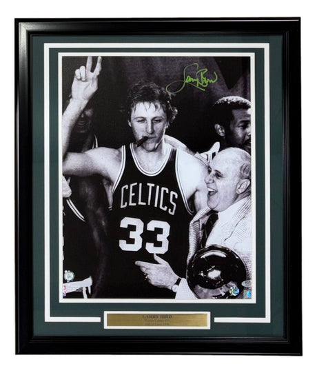 Sports Integrity Larry Bird Signed Framed 16x20 Boston Celtics Photo features Bird (#33) with Red Auerbach, posing with two fingers and a cigar. Includes green autograph and PSA/DNA authentication.