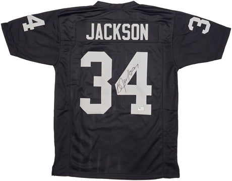 The Sports Integrity Bo Jackson Oakland Signed Black Football Jersey BAS features silver JACKSON and 34 on the back and sleeves, with Bo Jackson's autograph on the number 4.