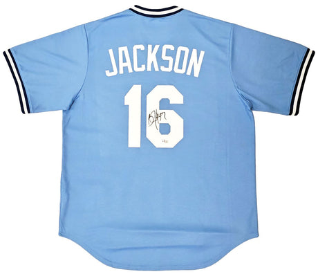 A light blue Nike Cooperstown Collection Royals jersey by Sports Integrity, featuring "JACKSON" and the number 16 in white with a black autograph on the back and black and white striped sleeves.
