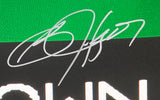 A close-up of Bo Jackson's silver autograph on a 16x20 Oakland Raiders Tecmo Bowl photo by Sports Integrity, with green, black, and partially visible white background and text below the signature.