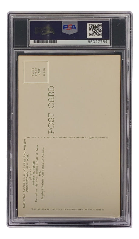A graded and encapsulated Bob Feller Signed 4x6 Cleveland Hall Of Fame Plaque Card by Sports Integrity is shown from the back, with PSA/DNA label, barcode, and cert number 85027784 visible at the top of the clear plastic case.