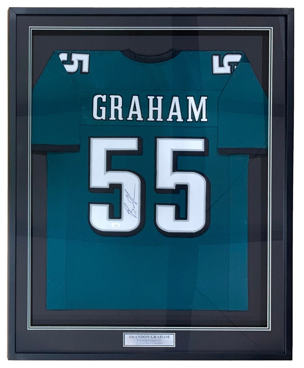 The Sports Integrity Brandon Graham SB 59 Champ Philadelphia green football jersey, signed and framed with "GRAHAM" and number 55, features a small centered plaque below the jersey inside the display. Authenticated by JSA.