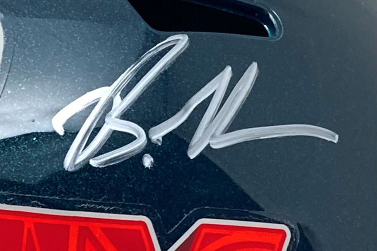 A close-up of the Brandon Graham Signed Eagles FS Super Bowl 59 LIX Replica Helmet by Sports Integrity, showcasing a bold silver autograph and part of a red sticker at the bottom; includes BAS authentication and display case.