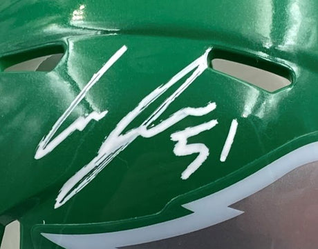 A close-up of the Sports Integrity Cam Jurgens Signed Eagles Kelly Green Mini Helmet with a white autograph and "59" above the face shield, displayed in a PSA/DNA Super Bowl LIX case.