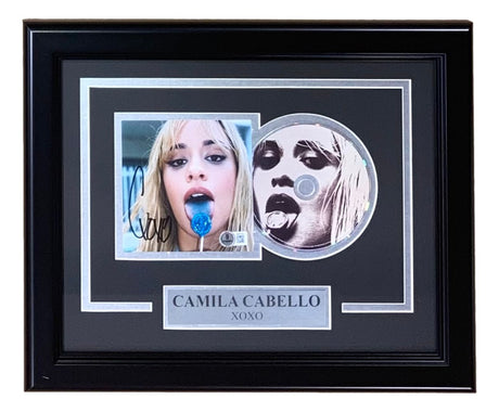 Sports Integrity’s Camila Cabello Signed Framed C,XOXO CD Insert BAS includes a signed photo of Camila with a blue lollipop, a CD insert with her black-and-white portrait, and a CAMILA CABELLO XOXO nameplate.