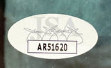 Sports Integrity Carl Weathers signed framed 8x10 Predator photo features an oval JSA sticker with a faded logo, black signature, and bold black code “AR51620” inside a rectangle on a greenish background.
