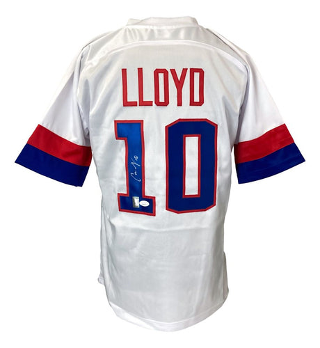 The Sports Integrity Carli Lloyd USA Signed White Soccer Jersey features red and blue sleeve stripes, LLOYD in red, number 10 in blue with a red outline on the back, and Carli Lloyd’s signature on the number 1.