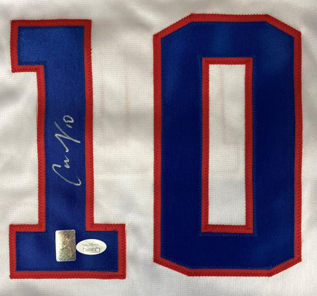 A close-up of the Carli Lloyd USA Signed White Soccer Jersey by Sports Integrity, showing a large blue and red number 10 with Lloyd's signature on the number 1 and two authenticity stickers below.