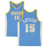 Two views of a blue Carmelo Anthony Signed Denver Nuggets 2003/04 M&N Swingman Jersey by Sports Integrity, featuring yellow trim, number 15, "Anthony" on the back, and an autograph on the number.