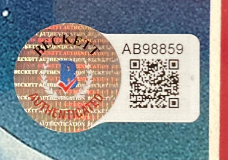 A Beckett Authentication sticker with a holographic seal, serial AB98859, and QR code is affixed to the Sports Integrity Chevy Chase Signed Framed 11x17 Lampoons Christmas Vacation Photo BAS.