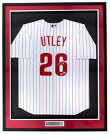 The Sports Integrity Chase Utley Signed Framed Philadelphia Phillies Nike Limited Jersey features UTLEY and 26 in red, an autograph on the number, red pinstripes, a white background, a black/red border, and a nameplate.