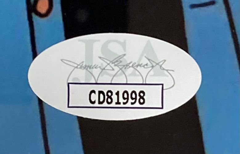 A close-up of an oval JSA authentication sticker featuring a black signature and code CD81998 on the Cheech & Chong Signed Framed 8x10 The Simpsons Photo 2 by Sports Integrity.