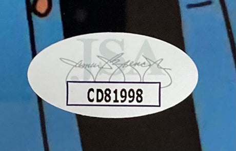 A close-up of an oval JSA authentication sticker featuring a black signature and code CD81998 on the Cheech & Chong Signed Framed 8x10 The Simpsons Photo 2 by Sports Integrity.