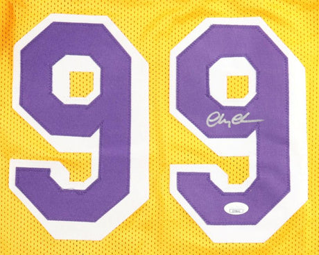 The Sports Integrity Chevy Chase Signed Los Angeles Yellow Fletch Basketball Jersey features large purple and white number 99, a silver autograph on the right-side 9, and a JSA hologram for authentication.
