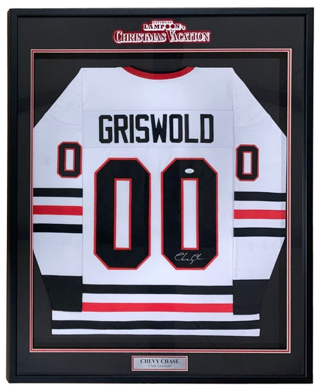 The Sports Integrity Chevy Chase Signed Framed Lampoon’s Christmas Vacation White Griswold Jersey (JSA) features GRISWOLD and 00 in black, a Chevy Chase nameplate, autograph, and display referencing the film.