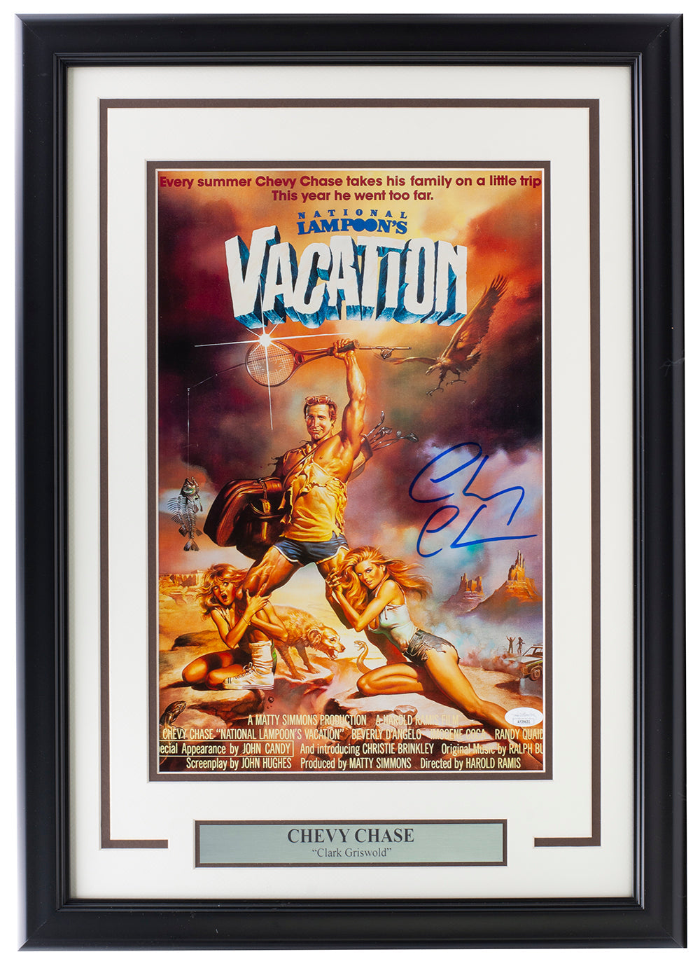The Chevy Chase Signed Framed 11x17 National Lampoons Vacation Photo by Sports Integrity features his autograph and comes with JSA authentication.