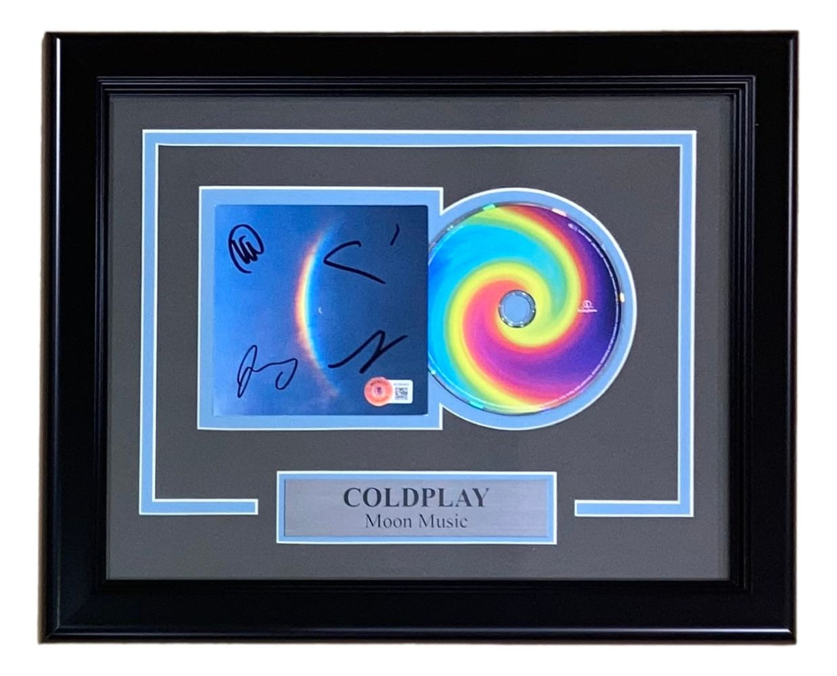 Framed display by Sports Integrity featuring a signed Cold Play Moon Music CD insert (BAS LOA), matching CD, and a plaque labeled "COLDPLAY Moon Music.