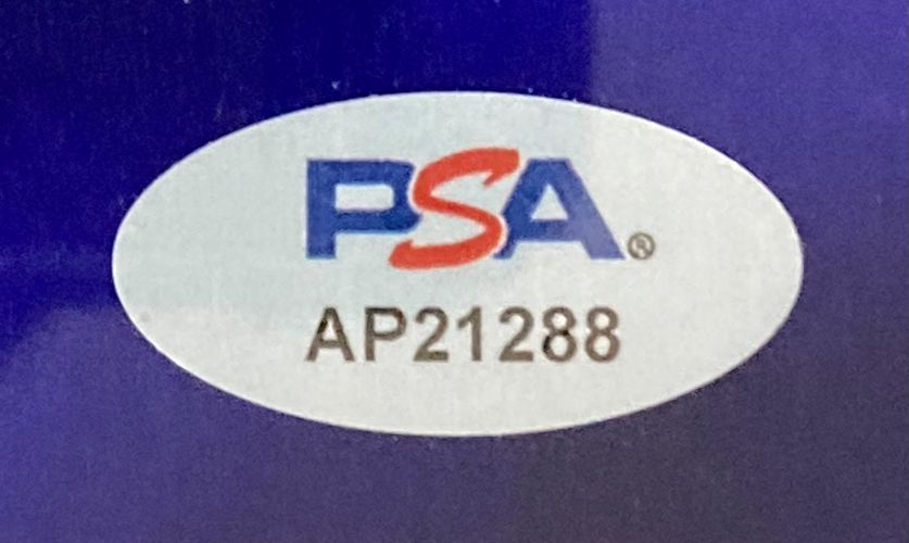 A white oval sticker featuring the PSA/DNA logo in blue and red and code AP21288 is included with the Sports Integrity Conor McGregor Signed Framed 8x10 UFC Photo.
