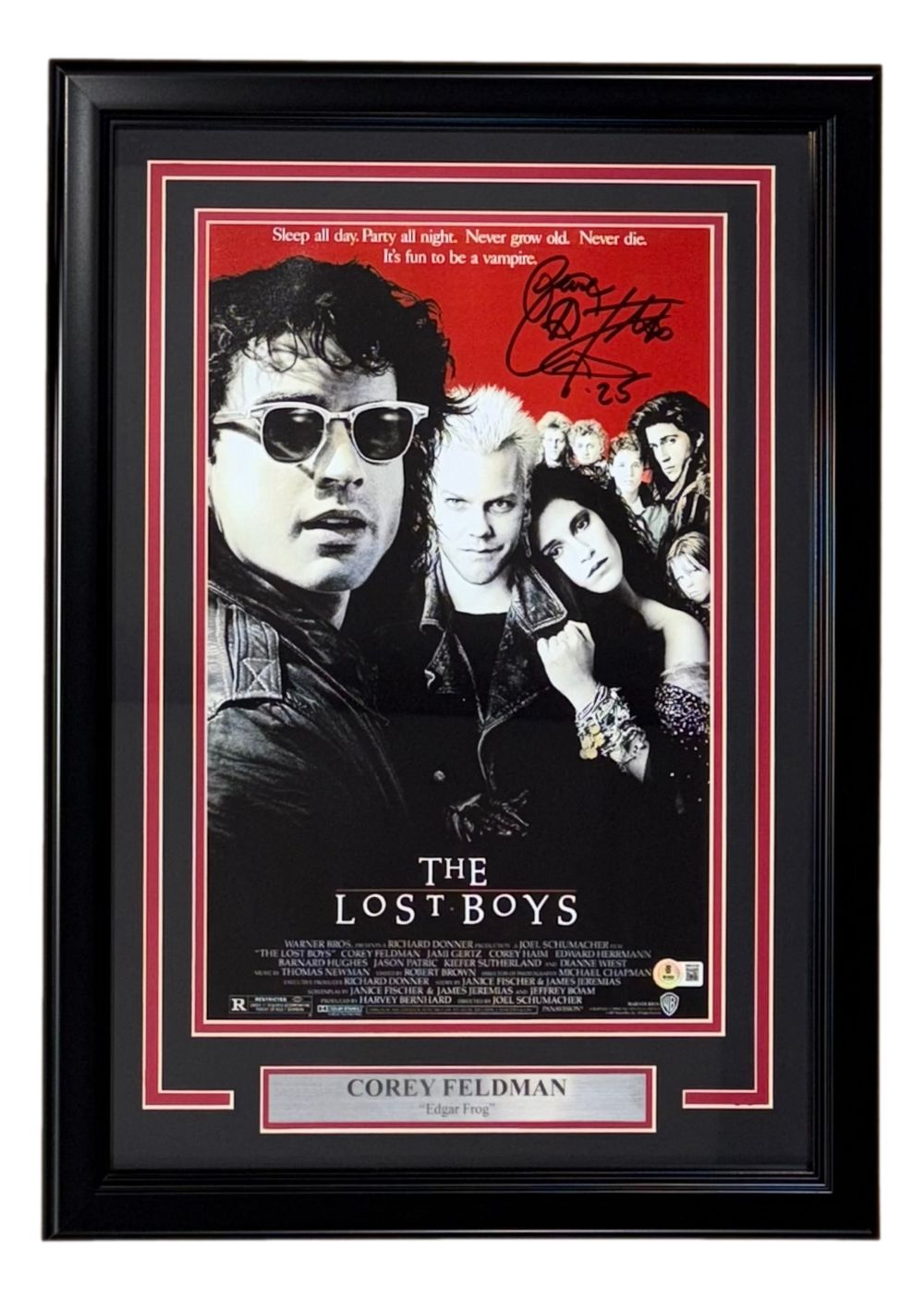 Sports Integrity's Corey Feldman Signed Framed 11x17 The Lost Boys photo features Feldman's autograph with "Peace" inscription, a plaque reading "Corey Feldman Edgar Frog," and the main cast on a red and black background.