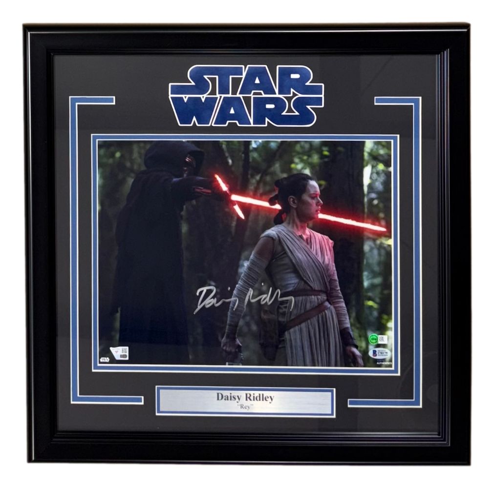The Sports Integrity Daisy Ridley Signed Framed 11x14 Star Wars The Force Awakens Photo by Fanatics+BAS shows Rey facing Kylo Ren, with a Star Wars logo and nameplate.