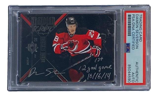 Sports Integrity Damon Severson Signed 2015 Upper Deck #OS-DA Devils hockey card in PSA/DNA holder, featuring handwritten notes: "1st," "2 goal game," and "10/16/14." Player shown in New Jersey Devils red uniform.