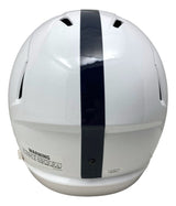 A Dani Dennis-Sutton signed Penn State full size speed replica helmet by Sports Integrity, featuring a white design with a single dark blue vertical stripe down the center and a visible warning label near the bottom.