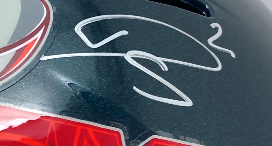 A close-up of the Darius Slay Signed Philadelphia Eagles FS Super Bowl 59 LIX Replica Helmet by Sports Integrity, featuring a bold white signature on the shiny black surface with red and white design elements visible on the left.