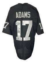 The Sports Integrity Davante Adams Oakland black football jersey features "ADAMS" and the number 17 in white on the back and sleeves, with an autograph on the back number. BAS ITP authenticated.