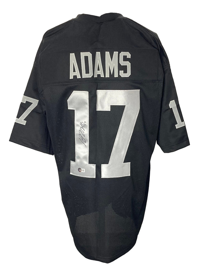The Sports Integrity Davante Adams Oakland black football jersey features "ADAMS" and the number 17 in white on the back and sleeves, with an autograph on the back number. BAS ITP authenticated.