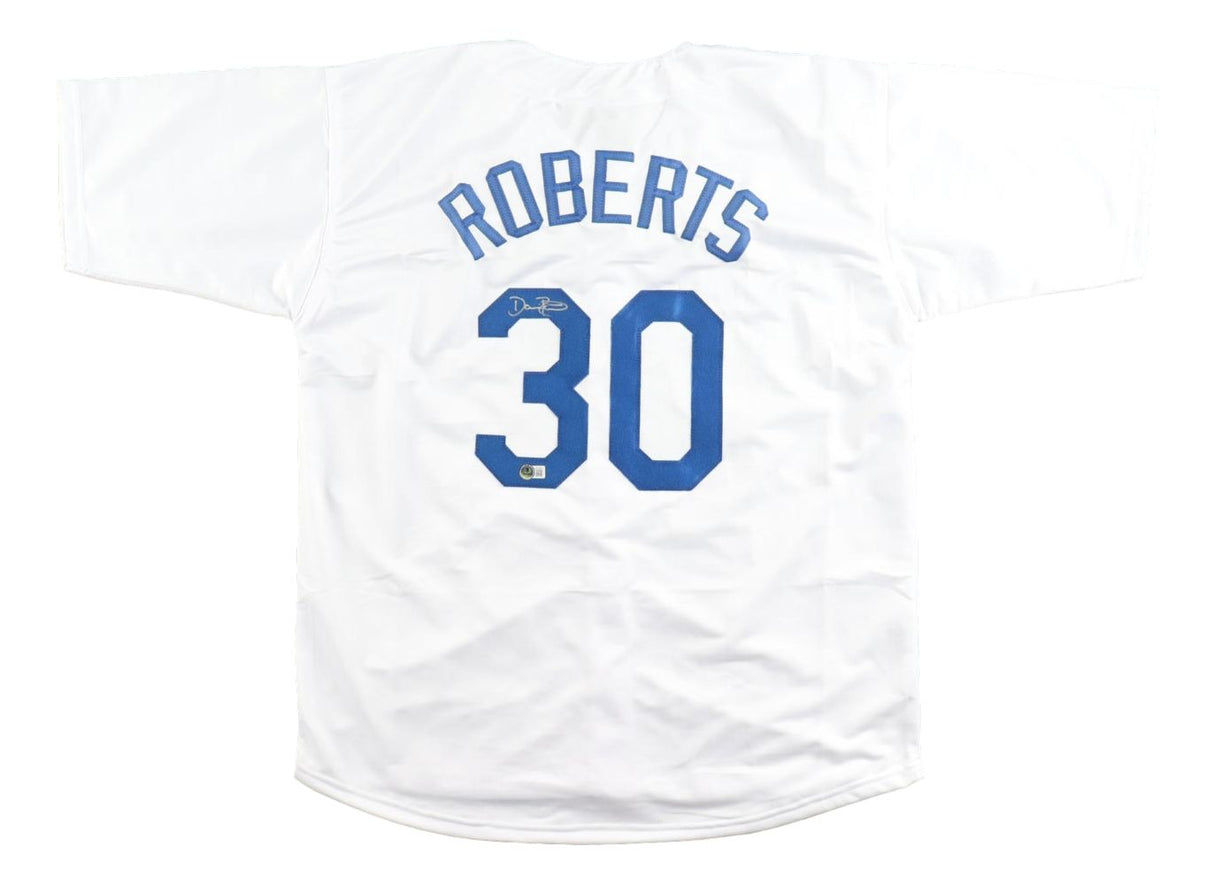 A Dave Roberts Los Angeles white baseball jersey by Sports Integrity is displayed flat, featuring blue "ROBERTS" text, number 30 on the back, and a small autograph above the number.