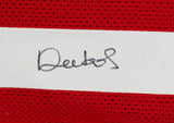 A close-up of a Deebo Samuel Signed Custom Red Pro Style Football Jersey by Sports Integrity, featuring a white stripe with a black autograph across it.