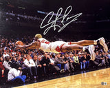Dennis Rodman, in a white and red Chicago Bulls uniform, dives to save the ball in this signed 16x20 photo from Sports Integrity, with spectators watching. His signature is clearly visible at the top of the image.