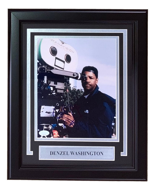 The Sports Integrity Denzel Washington Signed Framed 8x10 Photo (JSA) features Denzel in dark clothing beside a vintage film camera, with a nameplate below his image.