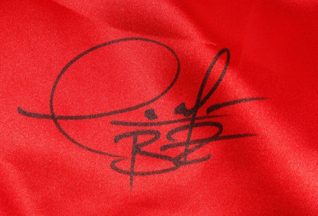 A bold black autograph with large, looping lines appears on smooth, bright red Deontay Wilder Signed Custom Boxing Trunks by Sports Integrity.