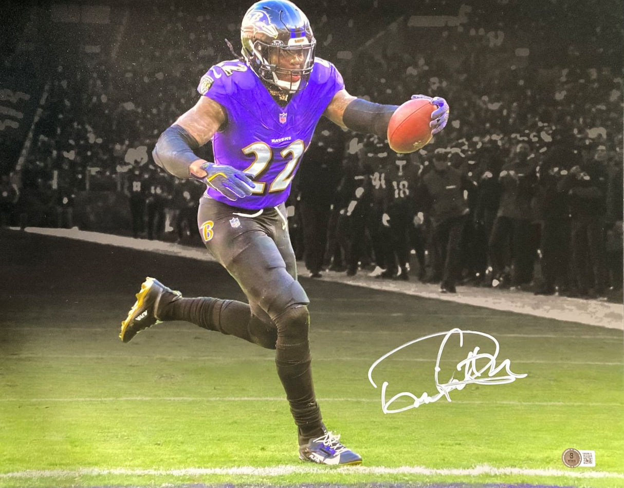 A football player in a purple Baltimore Ravens uniform runs with the ball on the field before cheering fans. The bottom right displays Derrick Henry's autograph. Product: Derrick Henry Signed 16x20 Baltimore Ravens Purple Jersey Photo by Sports Integrity.