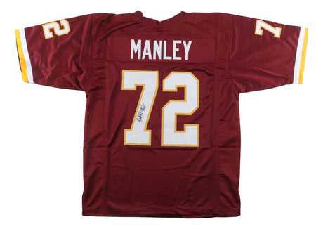 A Sports Integrity Dexter Manley Washington burgundy football jersey, featuring yellow and white accents, MANLEY and 72 on the back. The number 72 is autographed and JSA authenticated.